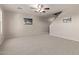 Bright living room with carpeted floor, ceiling fan, and large windows at 3234 S Bowman Rd, Apache Junction, AZ 85119