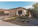 Single-story home with a two-car garage and desert landscaping with accent lighting at 337 W Stanley Ave, San Tan Valley, AZ 85140