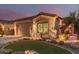 Single-story home with a two-car garage and desert landscaping with accent lighting at 337 W Stanley Ave, San Tan Valley, AZ 85140