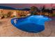 Freeform swimming pool with blue lighting and large patio at 337 W Stanley Ave, San Tan Valley, AZ 85140