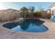 Inviting kidney-shaped pool with a waterfall feature in the backyard at 337 W Stanley Ave, San Tan Valley, AZ 85140