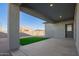 Covered patio with artificial turf and a gray block wall at 34909 N Palm Dr, San Tan Valley, AZ 85140