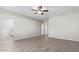 Bright bedroom with tile floors, ceiling fan, and ensuite bathroom at 34909 N Palm Dr, San Tan Valley, AZ 85140