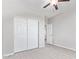 Bedroom with tile floors, ceiling fan, and double door closet at 34909 N Palm Dr, San Tan Valley, AZ 85140