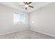 Well-lit bedroom with tile floors and ceiling fan at 34909 N Palm Dr, San Tan Valley, AZ 85140