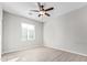 Spacious bedroom with tile floors, ceiling fan, and window at 34909 N Palm Dr, San Tan Valley, AZ 85140