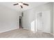 Bedroom with tile floors, ceiling fan, and access to bathroom at 34909 N Palm Dr, San Tan Valley, AZ 85140