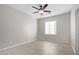 Well-lit bedroom with tile floors and ceiling fan at 34909 N Palm Dr, San Tan Valley, AZ 85140