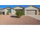 House exterior featuring gray walls, a two-car garage, and a small front yard at 34909 N Palm Dr, San Tan Valley, AZ 85140