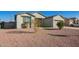 House exterior showcasing gray walls, a two-car garage, and a gravel driveway at 34909 N Palm Dr, San Tan Valley, AZ 85140