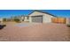 Two-car garage with a wood gate and a paved driveway at 34909 N Palm Dr, San Tan Valley, AZ 85140