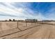 Single-story house on a vacant lot with chain link fence at 36747 W Harrison St, Tonopah, AZ 85354