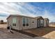 Single-story home with a gravel driveway and chain link fence at 36747 W Harrison St, Tonopah, AZ 85354