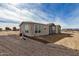 Single-story home with a gravel driveway and chain link fence at 36747 W Harrison St, Tonopah, AZ 85354