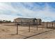 Side view of a single story home with a chain link fence at 36747 W Harrison St, Tonopah, AZ 85354