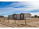 Beige and brown single-story home with a fenced yard at 36747 W Harrison St, Tonopah, AZ 85354