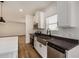 Modern kitchen with white cabinets, stainless steel appliances, and a farmhouse sink at 36747 W Harrison St, Tonopah, AZ 85354