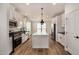 Modern kitchen with white cabinets, stainless steel appliances, and an island at 36747 W Harrison St, Tonopah, AZ 85354