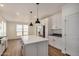 Modern kitchen with white cabinets, stainless steel appliances and island at 36747 W Harrison St, Tonopah, AZ 85354