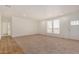 Spacious living room with light carpet and wood flooring at 36747 W Harrison St, Tonopah, AZ 85354