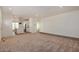 Open concept living room with view into kitchen and wood flooring at 36747 W Harrison St, Tonopah, AZ 85354