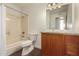 Bathroom with granite vanity, tub, and updated fixtures at 3744 W Malapai Dr, Phoenix, AZ 85051