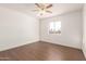 Well-lit bedroom with dark wood floors and a ceiling fan at 3744 W Malapai Dr, Phoenix, AZ 85051