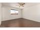 Spacious bedroom with dark wood floors and a ceiling fan at 3744 W Malapai Dr, Phoenix, AZ 85051