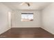 Bright bedroom featuring dark wood floors and a ceiling fan at 3744 W Malapai Dr, Phoenix, AZ 85051