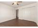 Spacious bedroom with dark wood floors and a ceiling fan at 3744 W Malapai Dr, Phoenix, AZ 85051