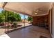 Covered back porch featuring ceiling fan, brick wall, and citrus tree view at 4054 E Clovis Cir, Mesa, AZ 85206