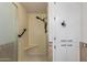 Bathroom with shower seat, hand rail, tiled walls, and built-in cabinet at 4054 E Clovis Cir, Mesa, AZ 85206