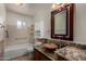 Bathroom with granite counters, decorative mirror, tile backsplash and vessel sink at 4054 E Clovis Cir, Mesa, AZ 85206