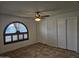 Bedroom with ceiling fan, large closet, and arched window at 4054 E Clovis Cir, Mesa, AZ 85206