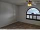 Bright bedroom with ceiling fan and arched window at 4054 E Clovis Cir, Mesa, AZ 85206