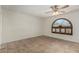 Spacious bedroom with tile flooring, a ceiling fan and a decorative window at 4054 E Clovis Cir, Mesa, AZ 85206