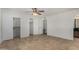 The well-lit bedroom offers tile flooring, a ceiling fan, and convenient closet storage at 4054 E Clovis Cir, Mesa, AZ 85206