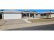 Charming brick home featuring a two-car garage, solar panels, arched windows and desert landscaping at 4054 E Clovis Cir, Mesa, AZ 85206