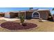 Charming brick home featuring a two-car garage, solar panels, arched windows and desert landscaping at 4054 E Clovis Cir, Mesa, AZ 85206