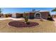 Charming single-story home with desert landscaping, solar panels, and a welcoming front porch and seating area at 4054 E Clovis Cir, Mesa, AZ 85206