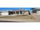 Charming brick home featuring a two-car garage, solar panels, arched windows and desert landscaping at 4054 E Clovis Cir, Mesa, AZ 85206