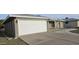 White garage door with a gravel driveway and some landscaping at 4054 E Clovis Cir, Mesa, AZ 85206