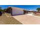 Spacious attached garage and concrete driveway offers convenience and ample parking space in the well maintained property at 4054 E Clovis Cir, Mesa, AZ 85206