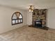 Living room with a stone fireplace, tile floors, and a ceiling fan at 4054 E Clovis Cir, Mesa, AZ 85206