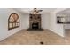 Spacious living room boasts tile flooring, a ceiling fan, and a charming decorative fireplace at 4054 E Clovis Cir, Mesa, AZ 85206