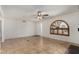 Bright living room featuring stylish tile flooring, ceiling fan, and a unique window design at 4054 E Clovis Cir, Mesa, AZ 85206