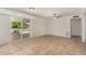 Bright living room features tile flooring, a ceiling fan, and sliding doors to the patio at 4054 E Clovis Cir, Mesa, AZ 85206