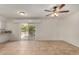 Bright living room features tile flooring, a ceiling fan, and sliding doors to the patio at 4054 E Clovis Cir, Mesa, AZ 85206