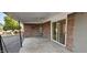 Covered patio with stone wall and ceiling fan at 4054 E Clovis Cir, Mesa, AZ 85206