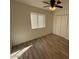 Spacious bedroom with wood-look tile flooring and double door closet at 4062 W Camino Acequia St, Phoenix, AZ 85051